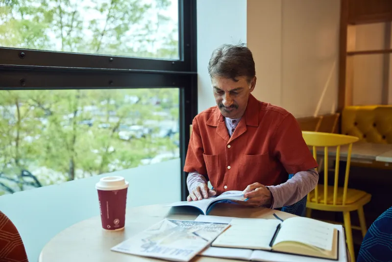 man sitting at a table looking through information
